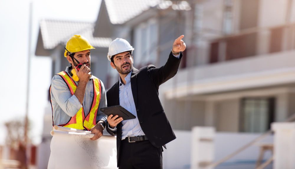 Two civil engineers working on the construction site.
