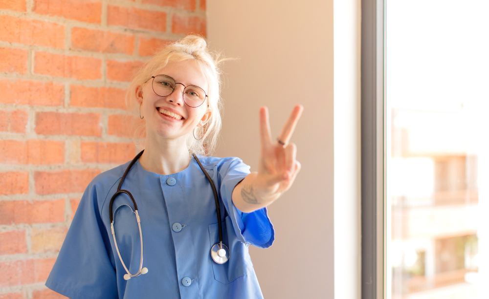 A nurse is smiling and looking happy.