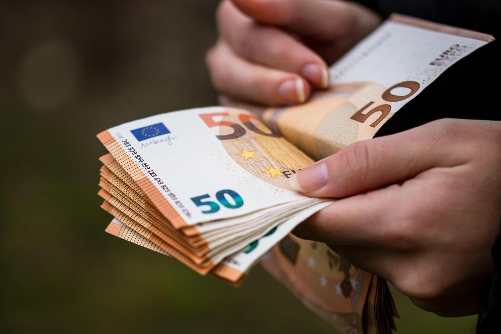 A hand counting euro.